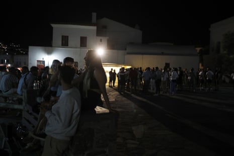 People gather in a square on Mykonos, late at night on Sunday.
