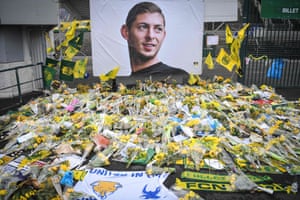 Yellow flowers are displayed in front of the portrait of Emiliano Sala at the Beaujoire stadium in Nantes.