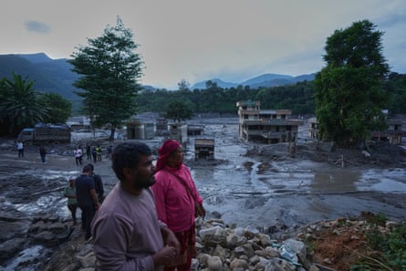 People in the foreground with a flooded landscape behind.