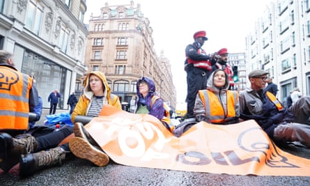 Protesters sit on the road outside Harrods