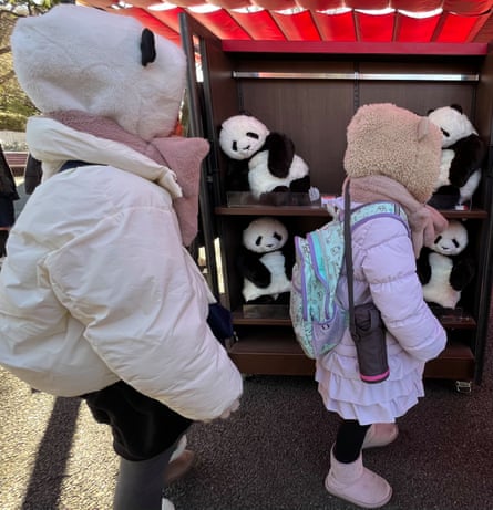 Panda fans walking past merchandise at The Panda House in Ueno Zoo