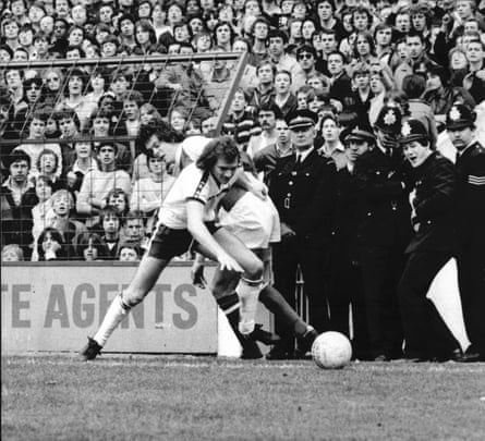 A policeman seems to be enjoying seeing David O’Leary and Chris Jones tussle during Arsenal’s 2-1 win at White Hart Lane on 7 April 1980.