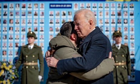 The pair embracing each other during a wreath laying ceremony at the Wall of Remembrance of the Fallen for Ukraine, in Kyiv.