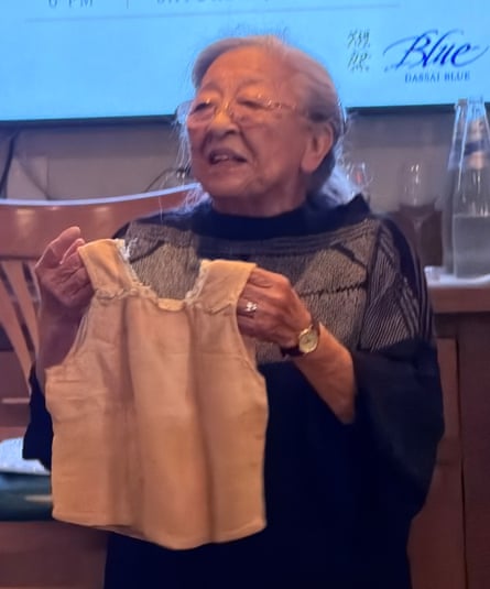 Koko holding up the dress at a public event