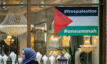 A shop front displaying the flag of Palestine in Alum Rock Road