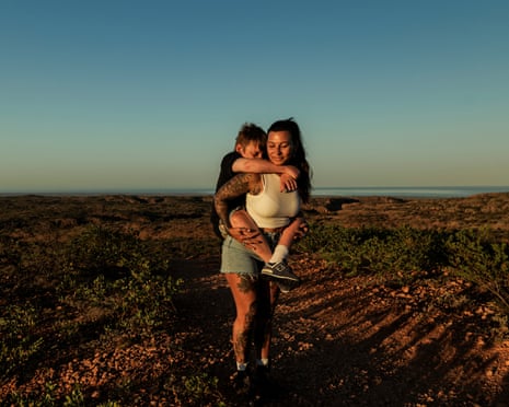 A woman carrying her son on her back