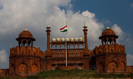 The Indian national flag flies at half-mast on the ramparts of Red Fort in Delhi.