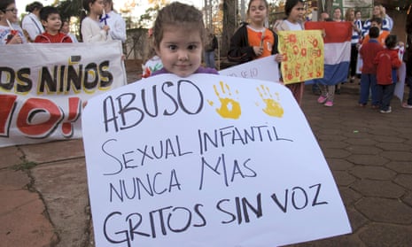 A child holds a sign that reads in Spanish ‘Child sexual abuse never again, screams without voice,’ at a demonstration in Ciudad del Este, Paraguay, in 2015.