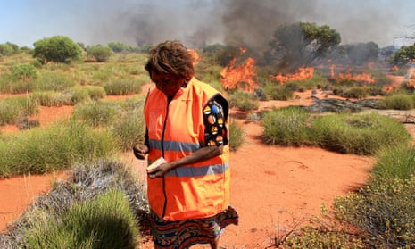 A traditional owner burning off in remote desert country
