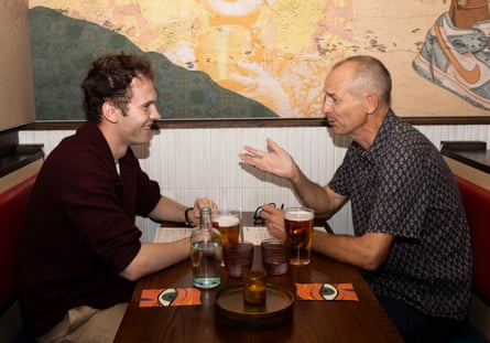 Adrian gesticulating and Oliver smiling