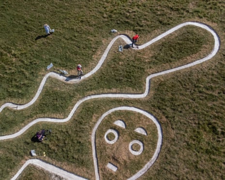 An aerial view of the Cerne Giant with volunteers working on its restoration
