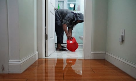 Mohammed Doha, 52, a construction worker, scoops contaminated water out of his flooded first-floor home in the Hole, one of the lowest neighborhoods in the Brooklyn borough of New York City, U.S., September 29, 2023.