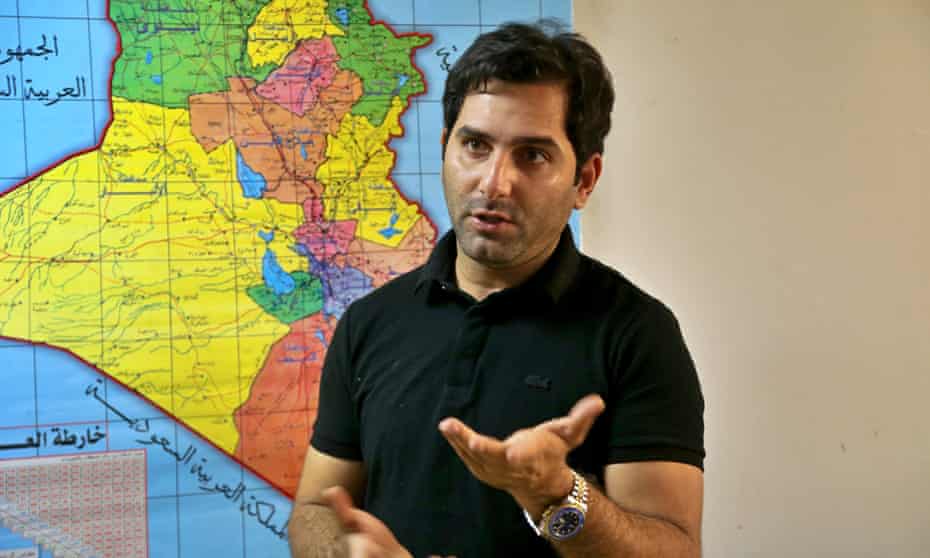 Raslan Haddad, the presenter of the local TV prank show, Tannab Raslan, stands in front of a map of Iraq during an interview with the Associated Press in Baghdad on Tuesday.