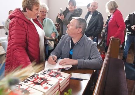John Davidson signs copies of his memoir, I Swear, about living with Tourette syndrome, at Wigtown book festival, Galloway, 4 October 2025.