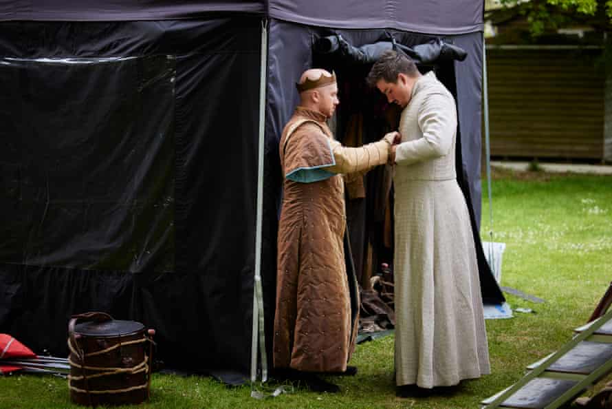 Laurie Scott (as Duncan) helps Michael Faulkner (as Malcolm) button up his coat. Each actor plays between two and four characters and costume changes must be be ready to come on to stage at the right moment.