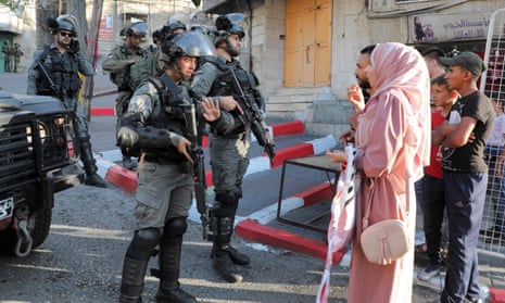 Israeli border guards block a street to Palestinians in the city of Hebron in the Israeli-occupied West Bank, 18 June 2021.