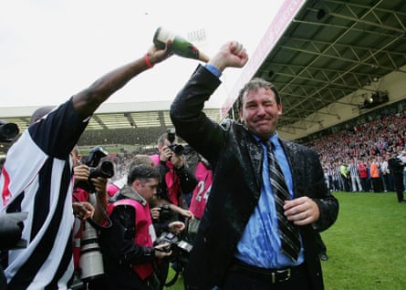 Kevin Campbell pours champagne over Bryan Robson after the club stay up in May 2005.