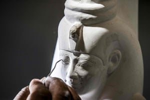 A technician crafts a replica of an ancient statue