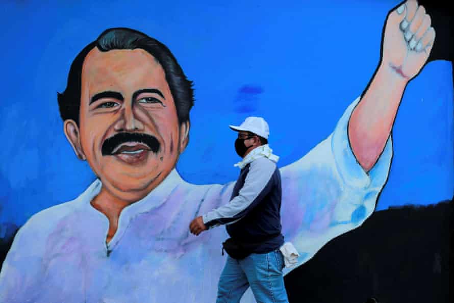 A man walks by a mural depicting President Daniel Ortega in Managua, Nicaragua.