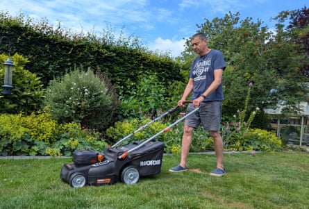 Andy Shaw mows his lawn on a clear day