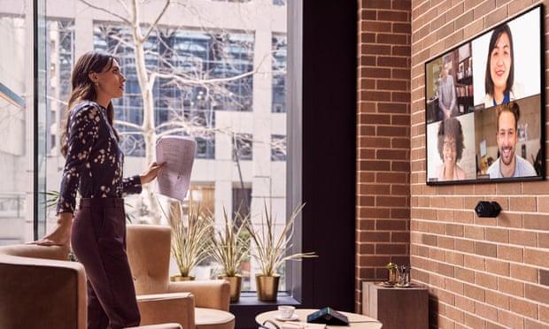 Woman talking to people on large screen