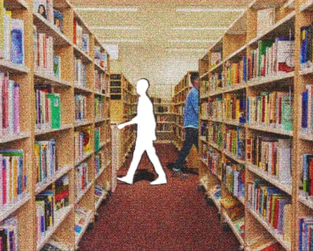 Silhouette of a person walking between bookshelves in a library aisle