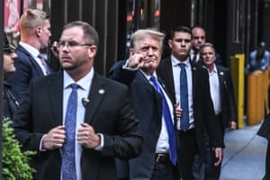 Former US president Donald Trump points at the crowd as he arrives at Trump Tower after the guilty verdict.
