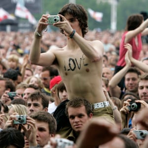 A member of the crowd takes a photograph of Travis at The Live 8 concert in Hyde Park London.