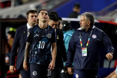 Miguel Almiron (10) of Paraguay reacts after receiving a red card for covering his mouth while talking to another player during the match.