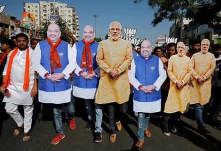 BJP supporters wearing cut-outs of Modi and the party president Amit Shah in Ahmedabadin 2019.