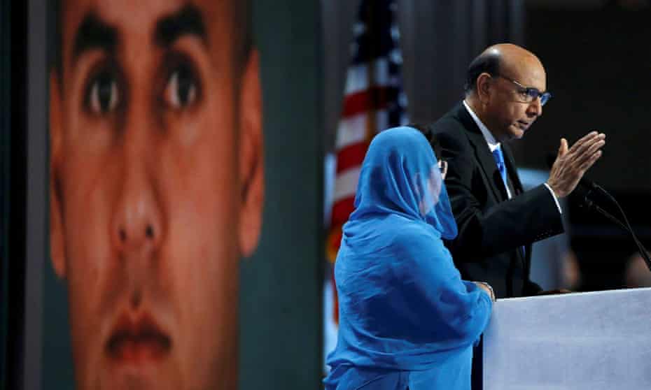 Khizr and Ghazala Khan stand in front of a portrait of their son at the Democratic national convention.