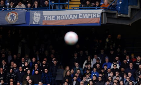 Chelsea fans watch a game against Newcastle under a banner relating to the ownership of Roman Abramovich