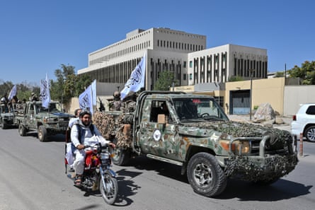 Taliban security personnel take part in a parade in front of the former US embassy in Kabul to celebrate the fifth anniversary of their return to power