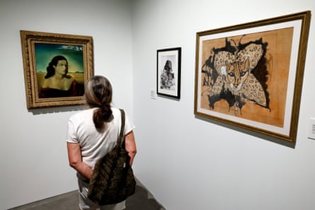 A gallery visitor looks at Dali’s Portrait de Mme Luther Greene (1942), Avida Dollars et son ocelot (1965) and Portrait de Babou (1968)