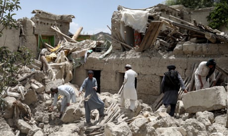 People search for survivors amid the debris of a house in Gayan, Afghanistan
