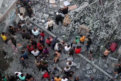 Palestinians search for survivors at the site of an Israeli strike on the al-Daraj neighbourhood in Gaza City on Friday.