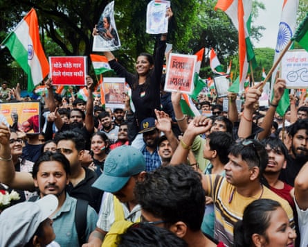 Cockroach Janta party (CJP) supporters celebrate the resignation of Education Minister Dharmendra Pradhan in Mumbai