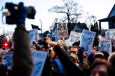 People hold signs at a protest.