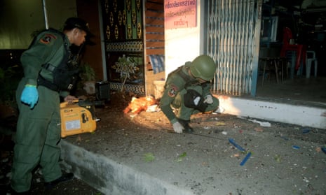 Members of the Explosive Ordnance Disposal unit inspect a bomb blast scene in Yala province, one of 17 such sites on the night of 14-15 May.