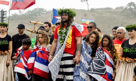 The protest have attracted international support, including from actor Jason Momoa pictured here with his children while visiting elders and Native Hawaiian protesters.