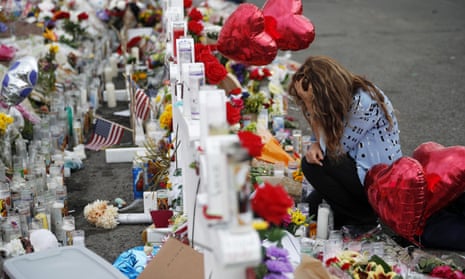 Gloria Garces kneels in front of crosses at a makeshift memorial near the scene of the El Paso shooting, 6 August 2019, in El Paso, Texas. 