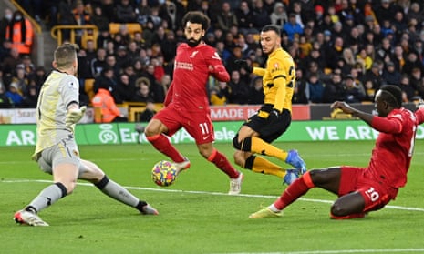 Liverpool’s Egyptian midfielder Mohamed Salah (2L) and Liverpool’s Senegalese striker Sadio Mane (R) fail to connect with a cross into the box.