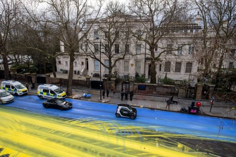 Activists pour paint on to the road to create a giant Ukrainian flag outside the Russian embassy in London.