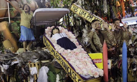 The Beija-Flor samba school performs with a coffin containing a doll representing a dead student.