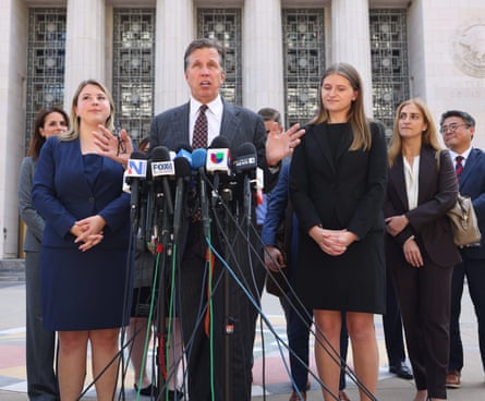 Lanier with his daughters Rachel (on left) and Sarah (right), who worked with him on the case, on the steps of the courthouse.
