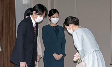 Mako bows to her father, Crown Prince Akishino, before leaving her home in Tokyo