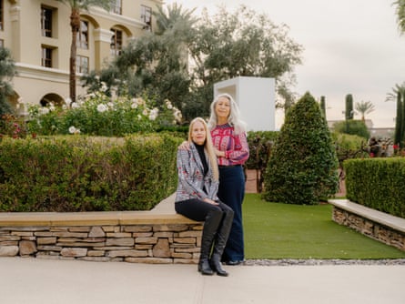 Carole Lieber Wilkins and Renée Ballou sitting on a wall