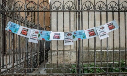 Anti-mafia posters hang from a gate in Castelvetrano