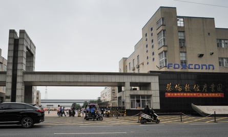 Workers arrive for their shifts at the Foxconn factory in Hengyang