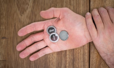 Ryan Gander’s hands holding three coins